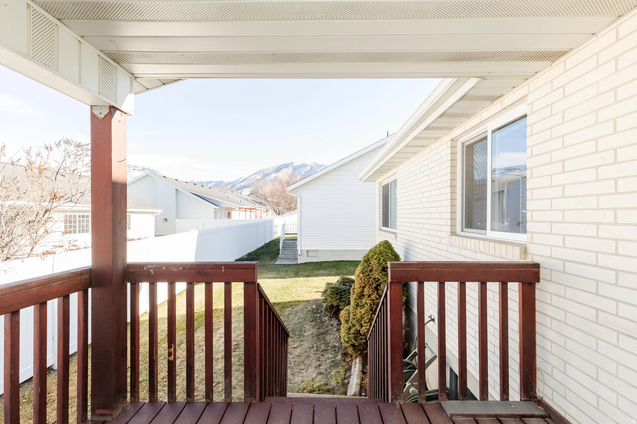 Deck featuring a fenced backyard and a mountain view
