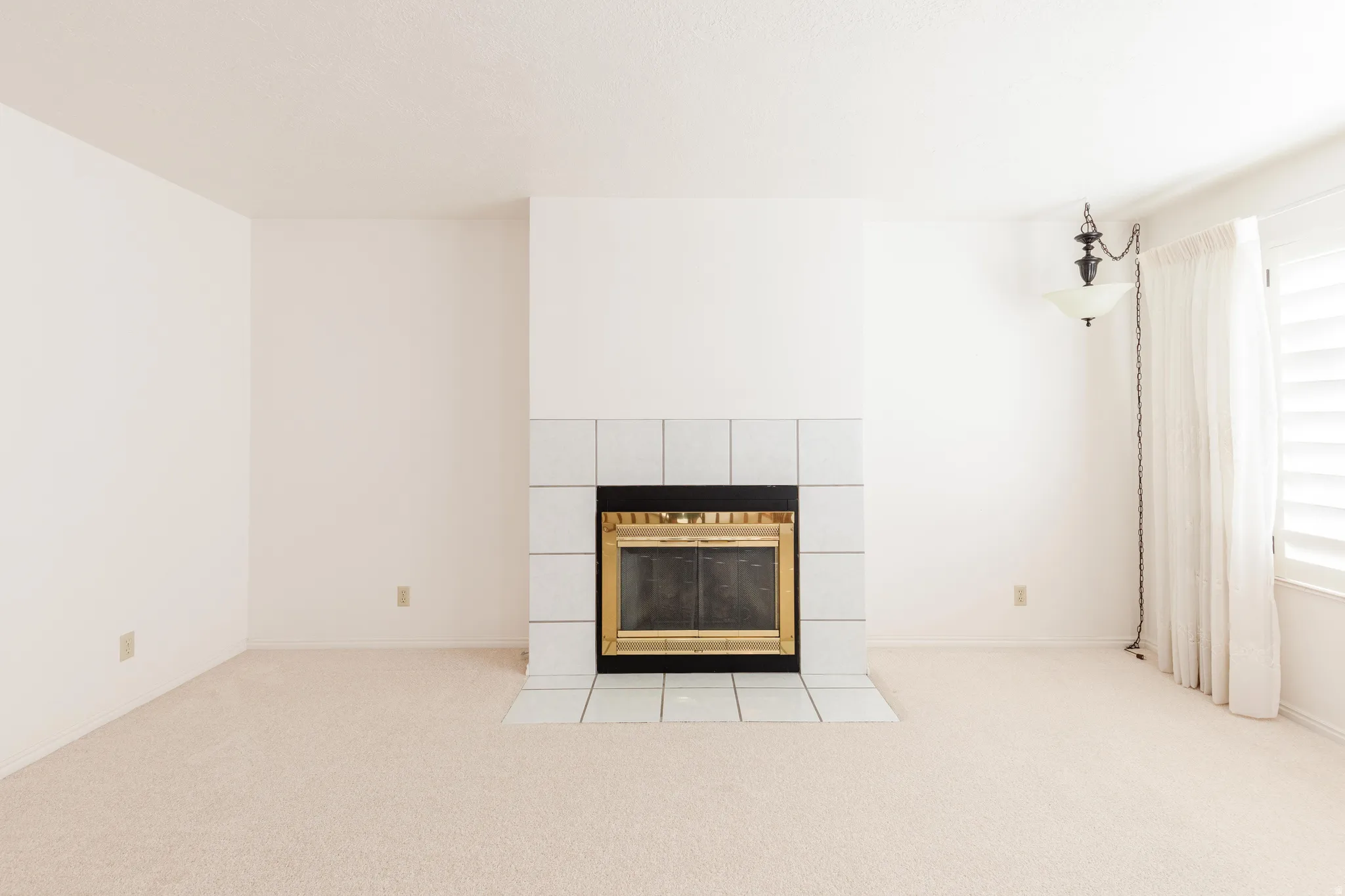 Detailed view of carpet and a tiled fireplace
