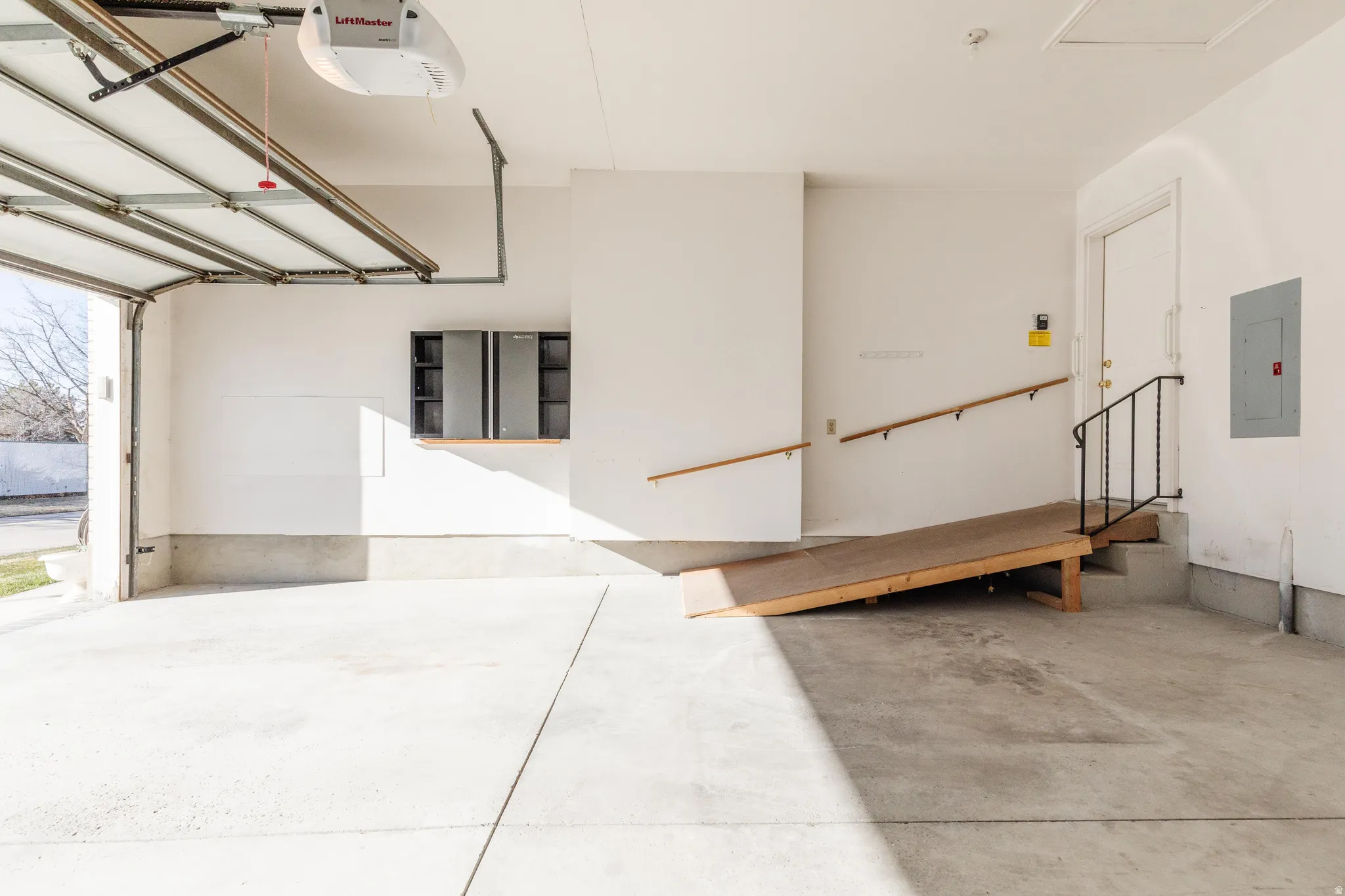 Garage with electric panel and a garage door opener