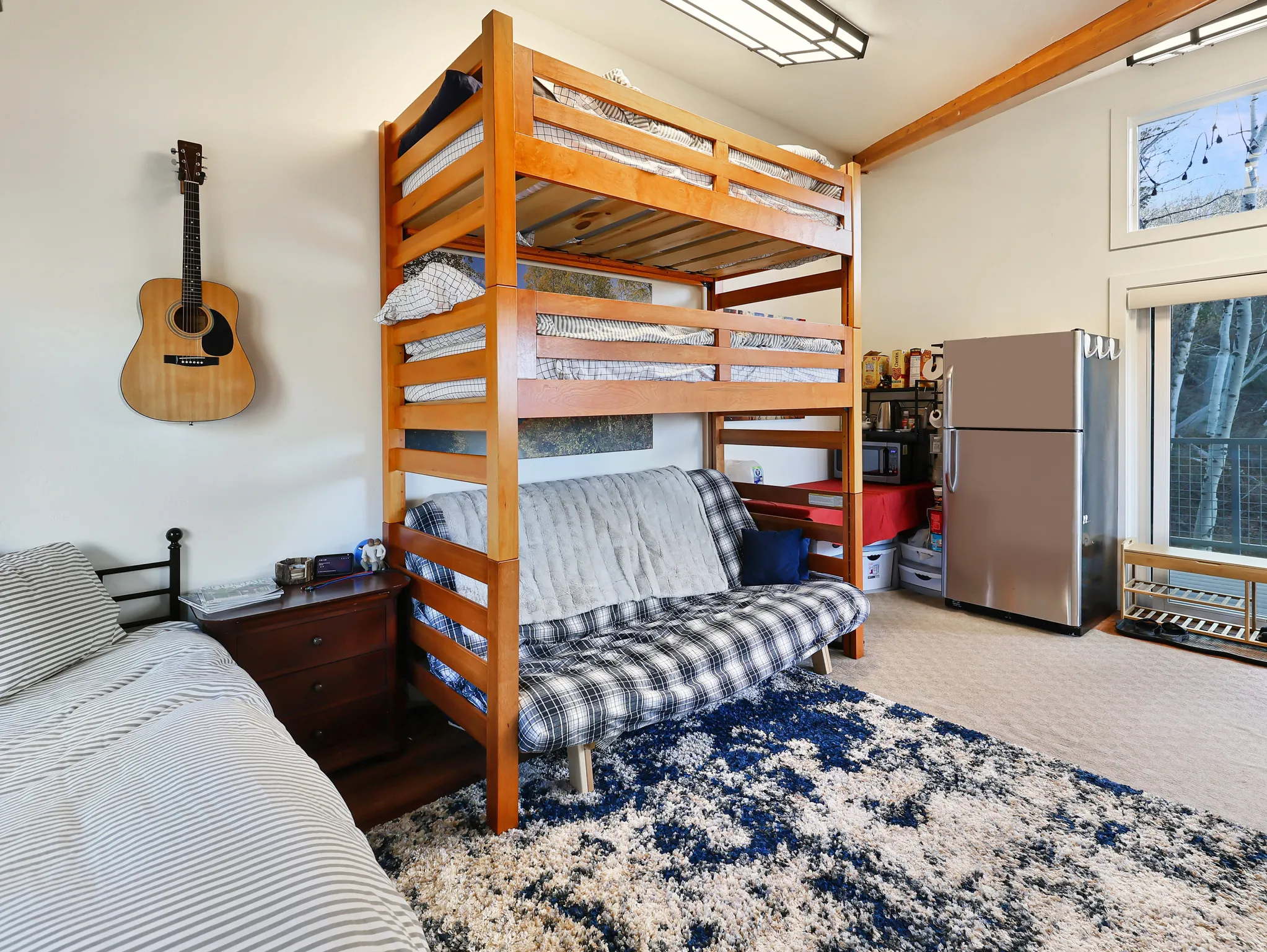 Bedroom featuring freestanding refrigerator and light colored carpet
