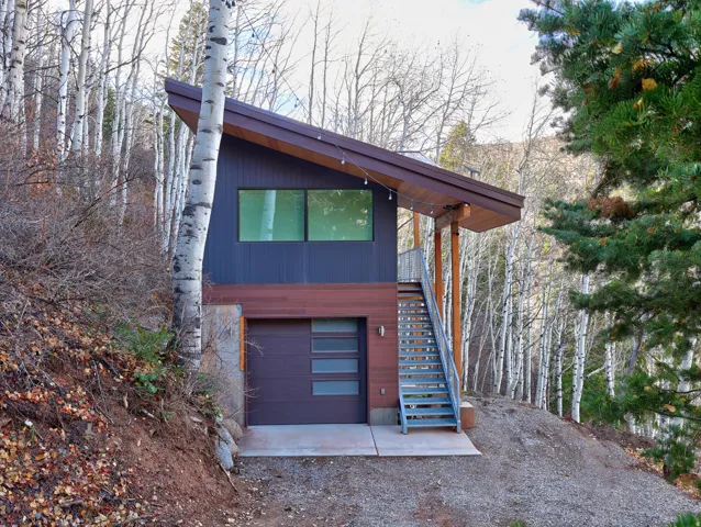 View of front of home featuring stairs and an attached garage