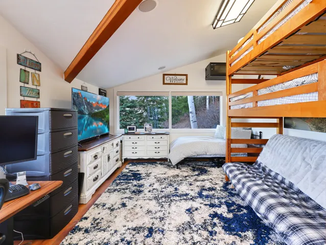 Bedroom with light wood-style flooring and a desk