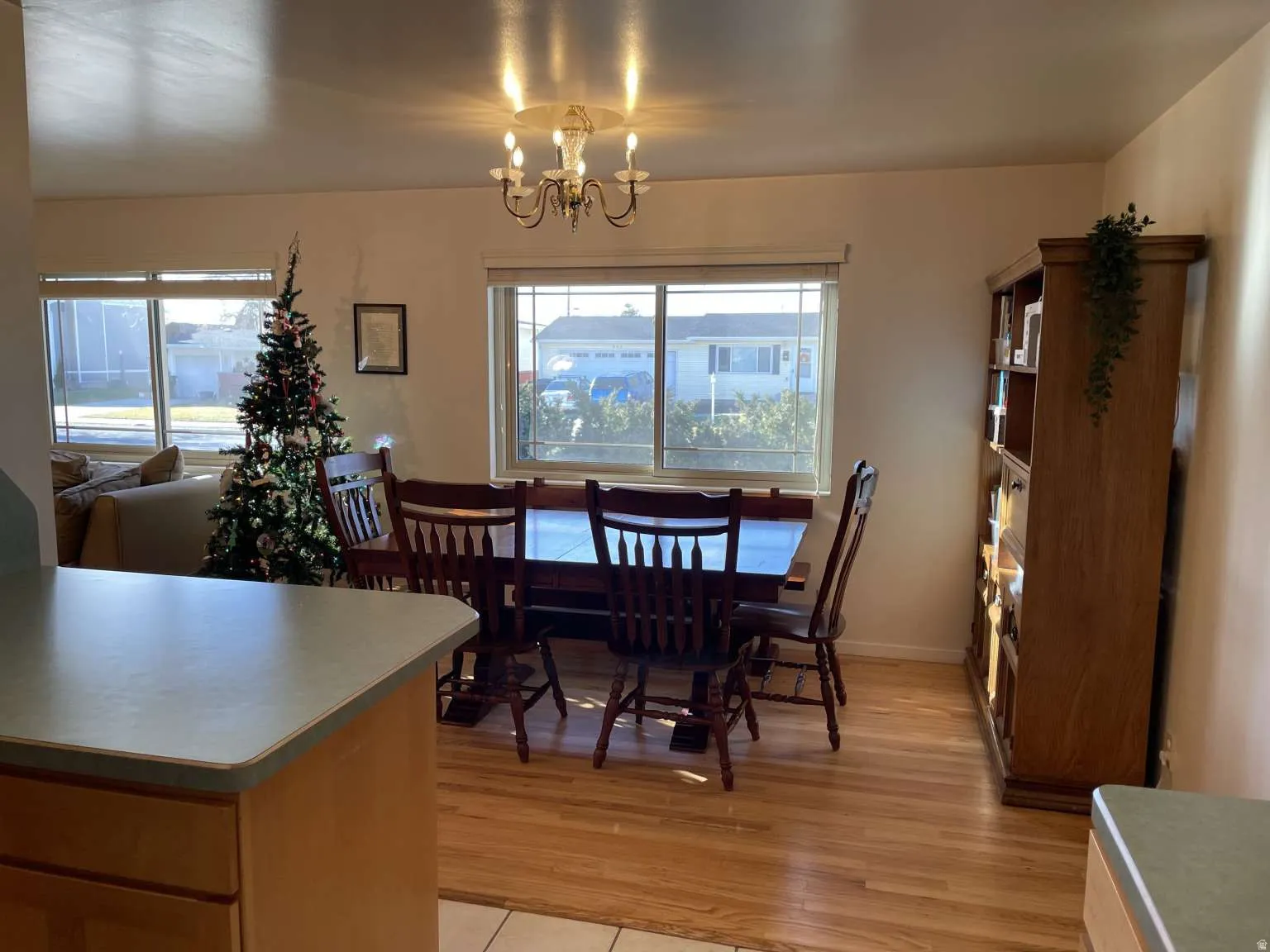 Dining room with healthy amount of natural light, a chandelier, and light wood-style floors