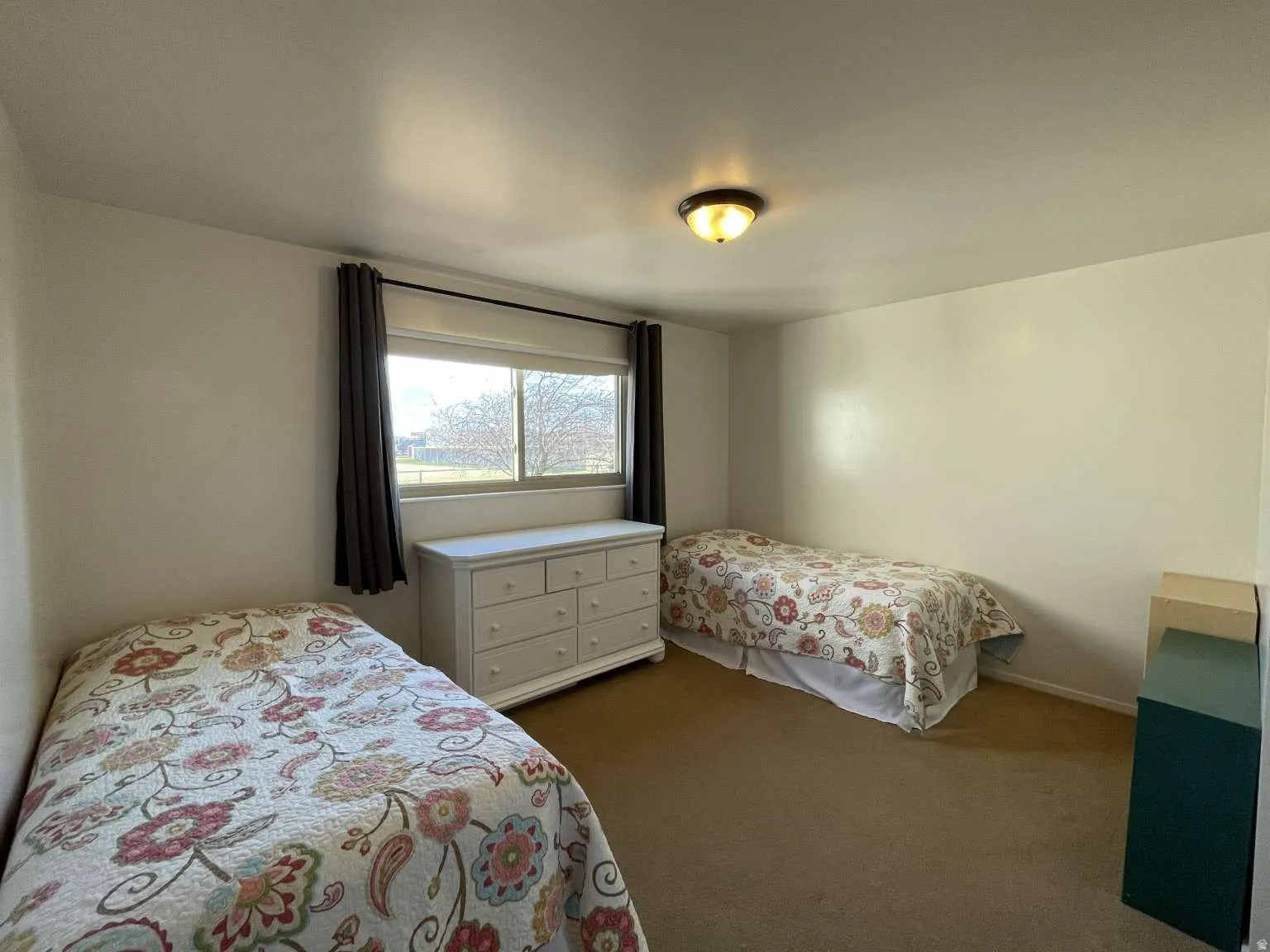 Bedroom with dark colored carpet