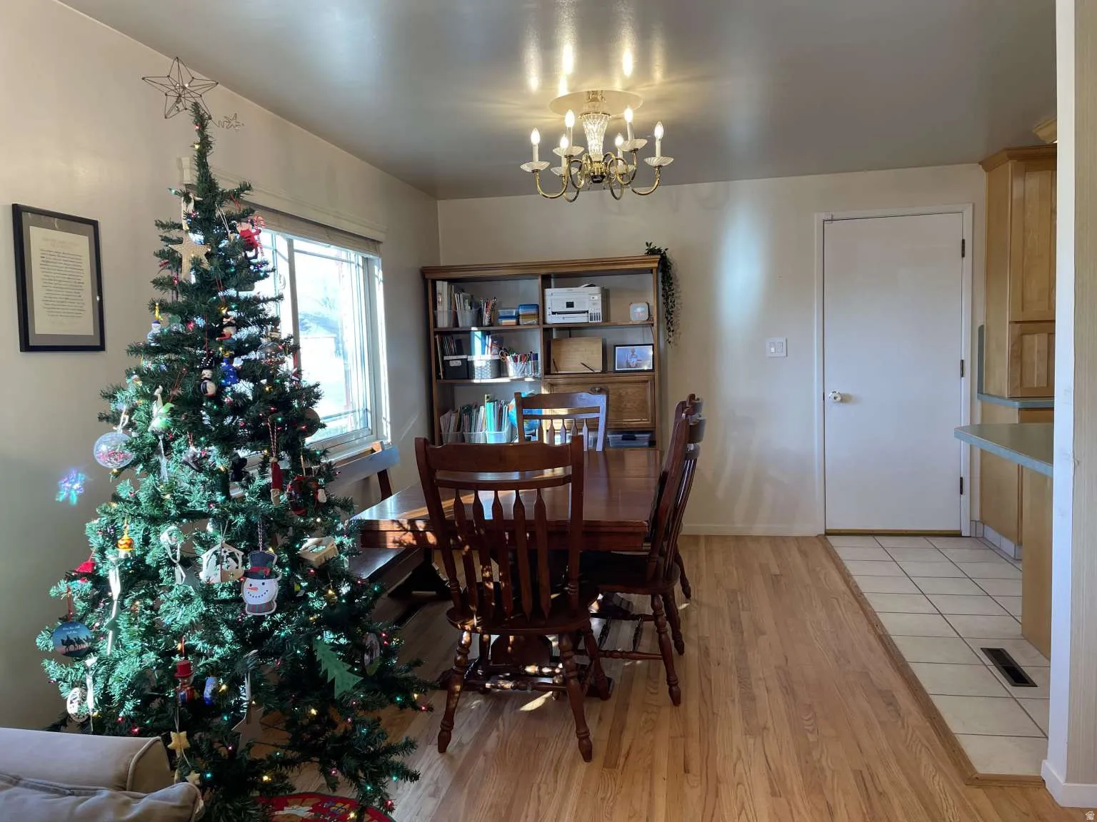 Dining room with light wood-style floors and a chandelier