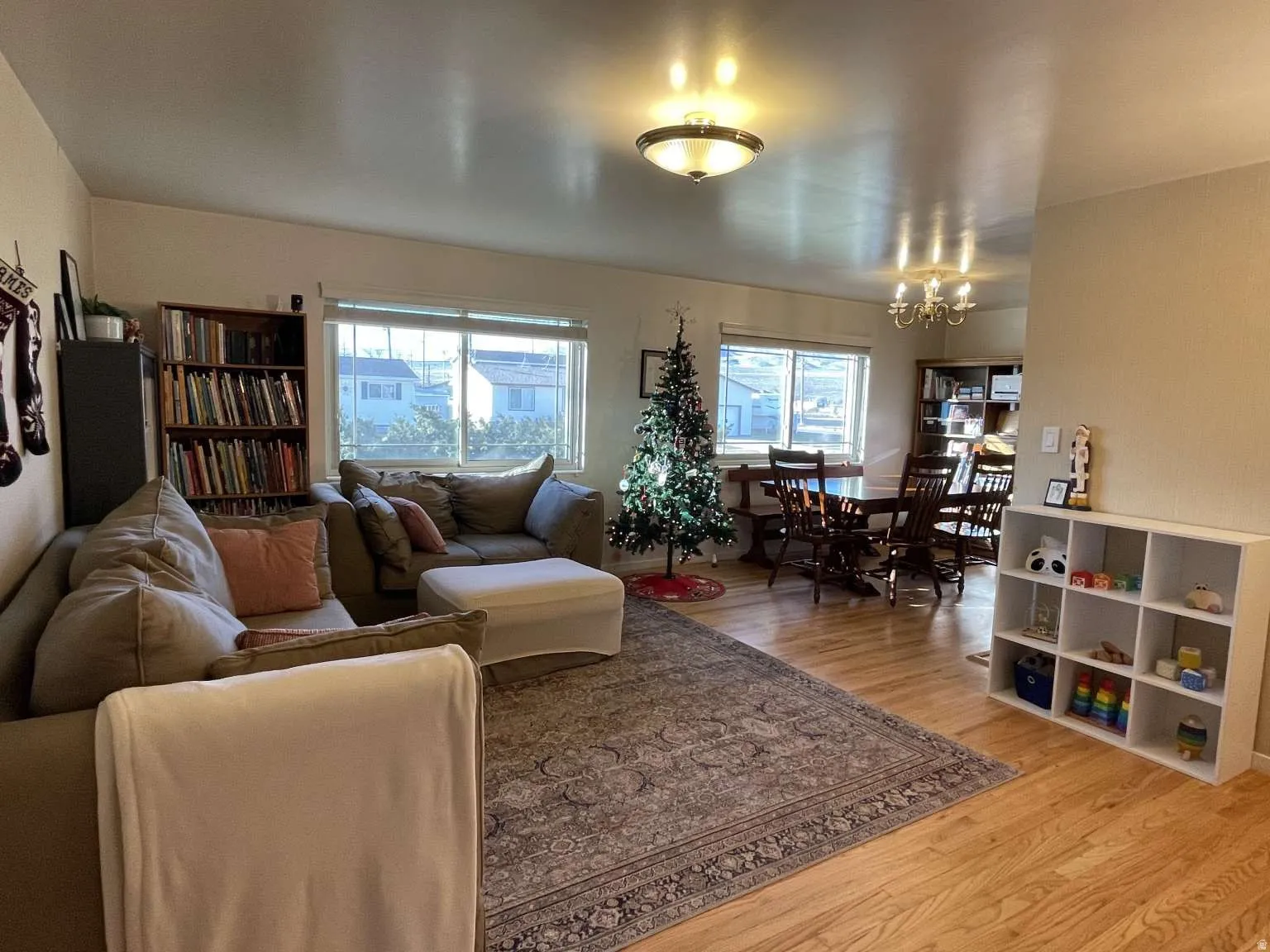 Living room with light wood-style flooring and a chandelier