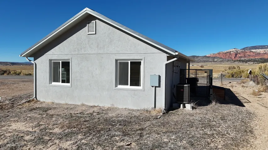 View of home's exterior featuring stucco siding and a cooling unit