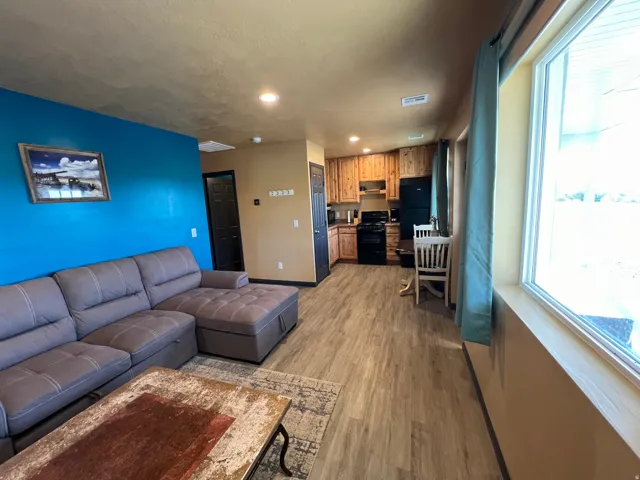 Living room featuring light wood-type flooring, recessed lighting, and a textured ceiling