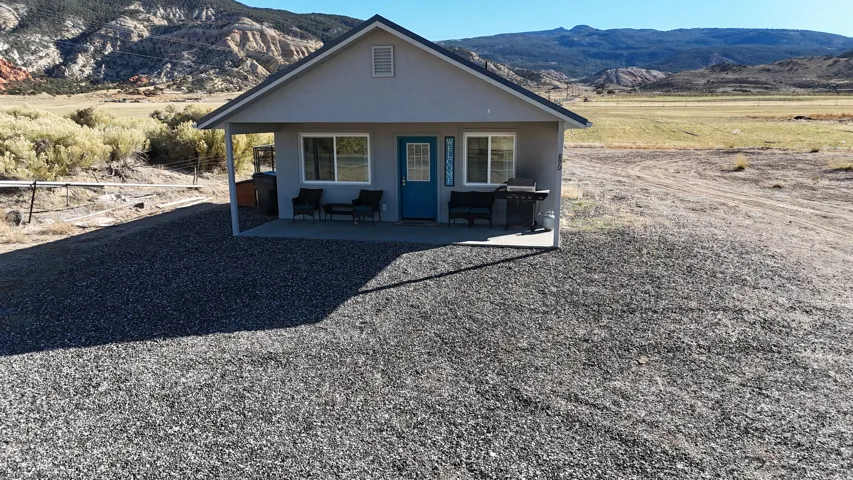 View of front of house featuring a mountain view, stucco siding, and a patio