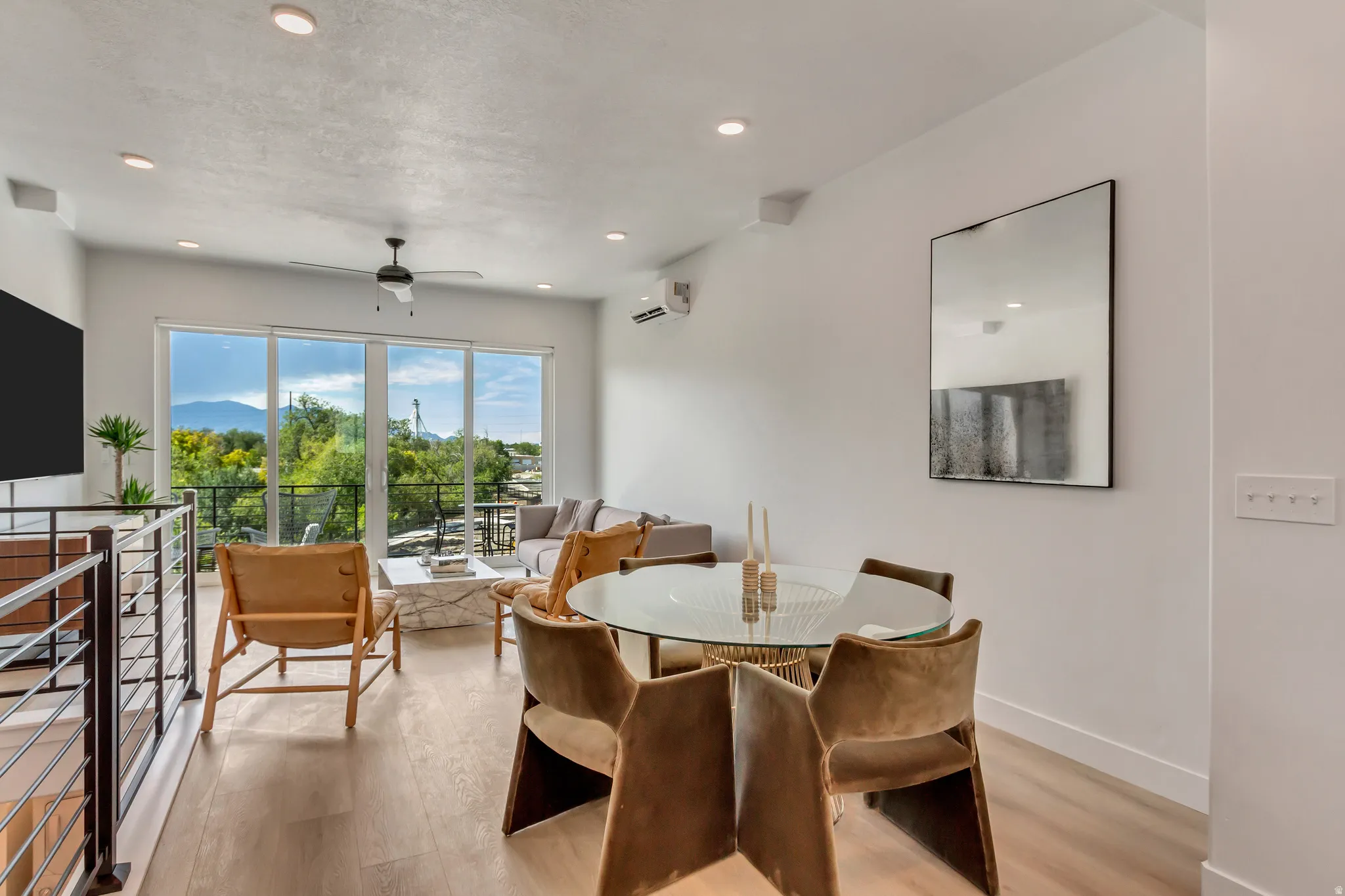 Dining area featuring light wood-style flooring, a ceiling fan, recessed lighting, and a mountain view