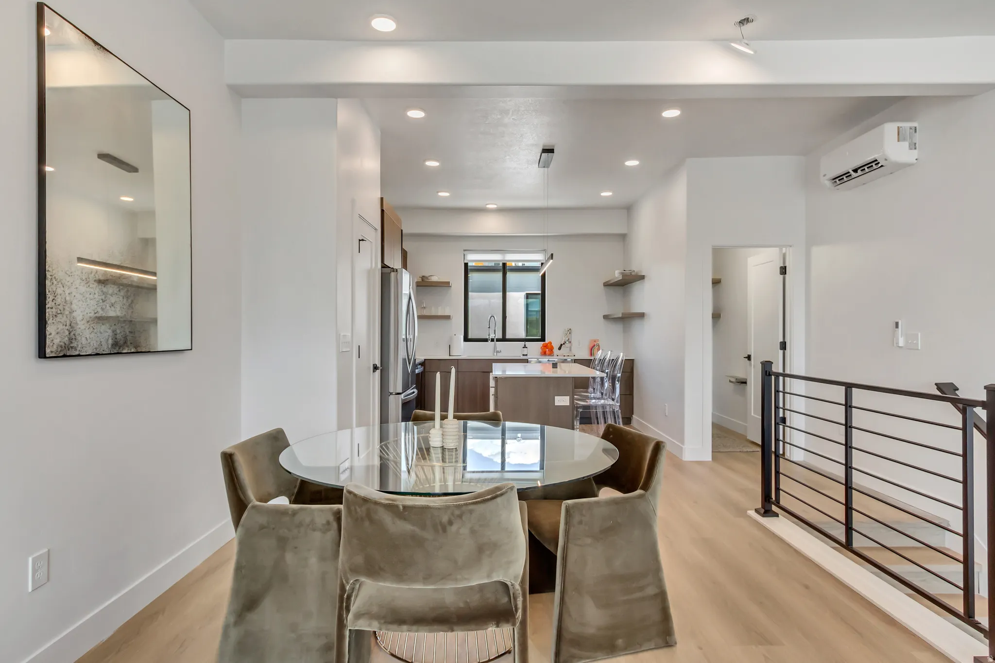 Dining room with light wood-style flooring, recessed lighting, and a wall mounted AC