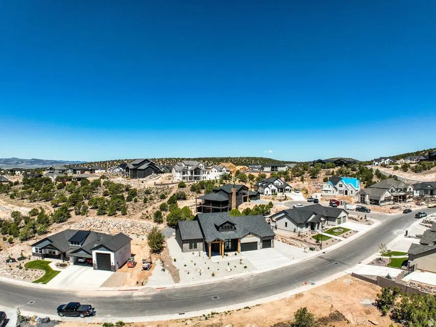 Expansive neighborhood development featuring a variety of architectural styles, paved streets, and natural desert landscaping