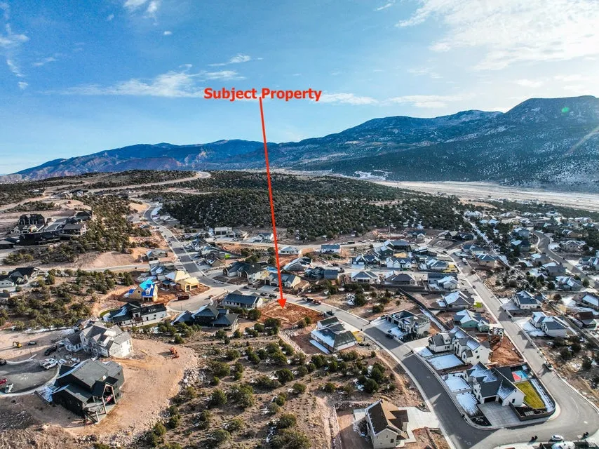 Aerial perspective of suburban area with a mountainous background