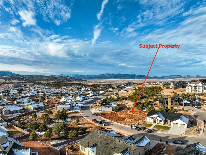 Aerial perspective of suburban area featuring a mountain backdrop