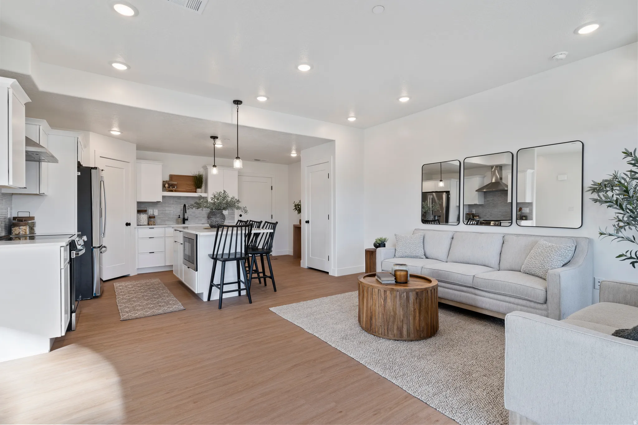 Living area with light wood-style floors and recessed lighting