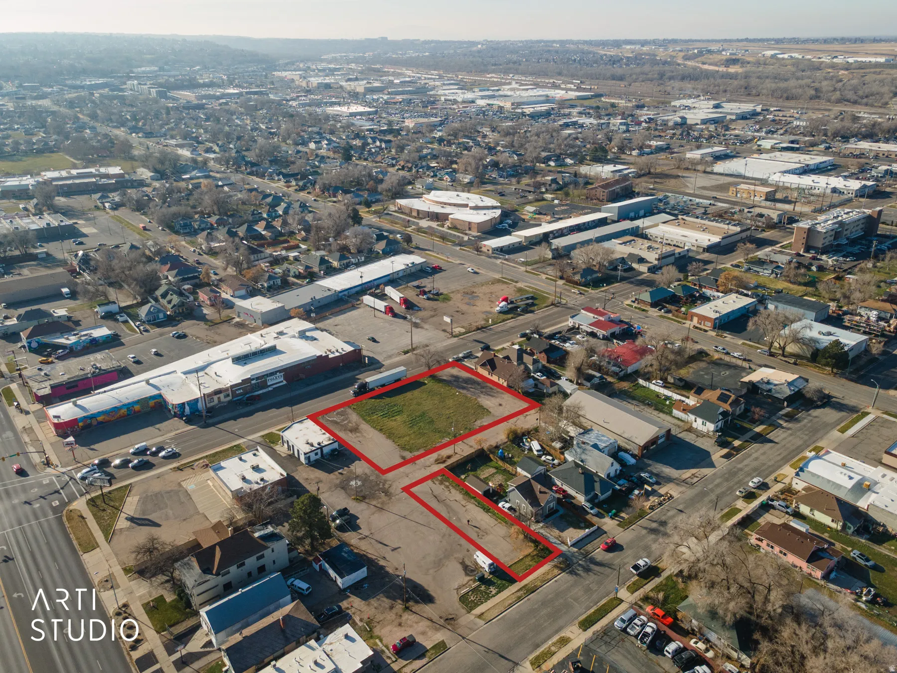Aerial view of property and surrounding area featuring industrial structures and property boundaries highlighted