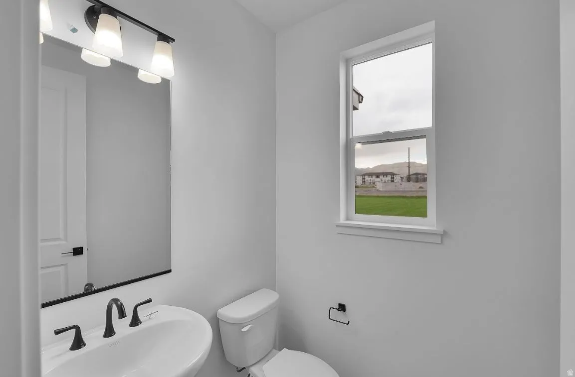 Half bathroom featuring a sink and toilet