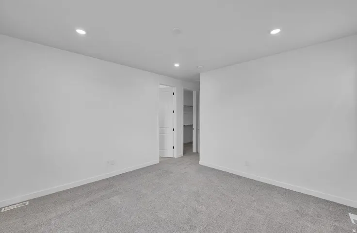 Unfurnished room with light carpet and recessed lighting