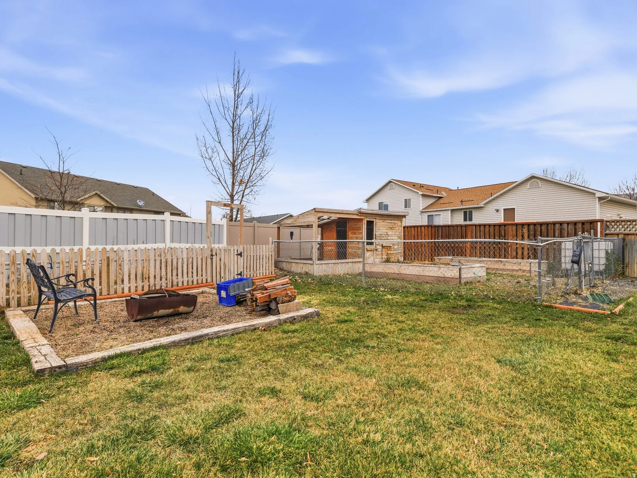 Fenced backyard with a vegetable garden