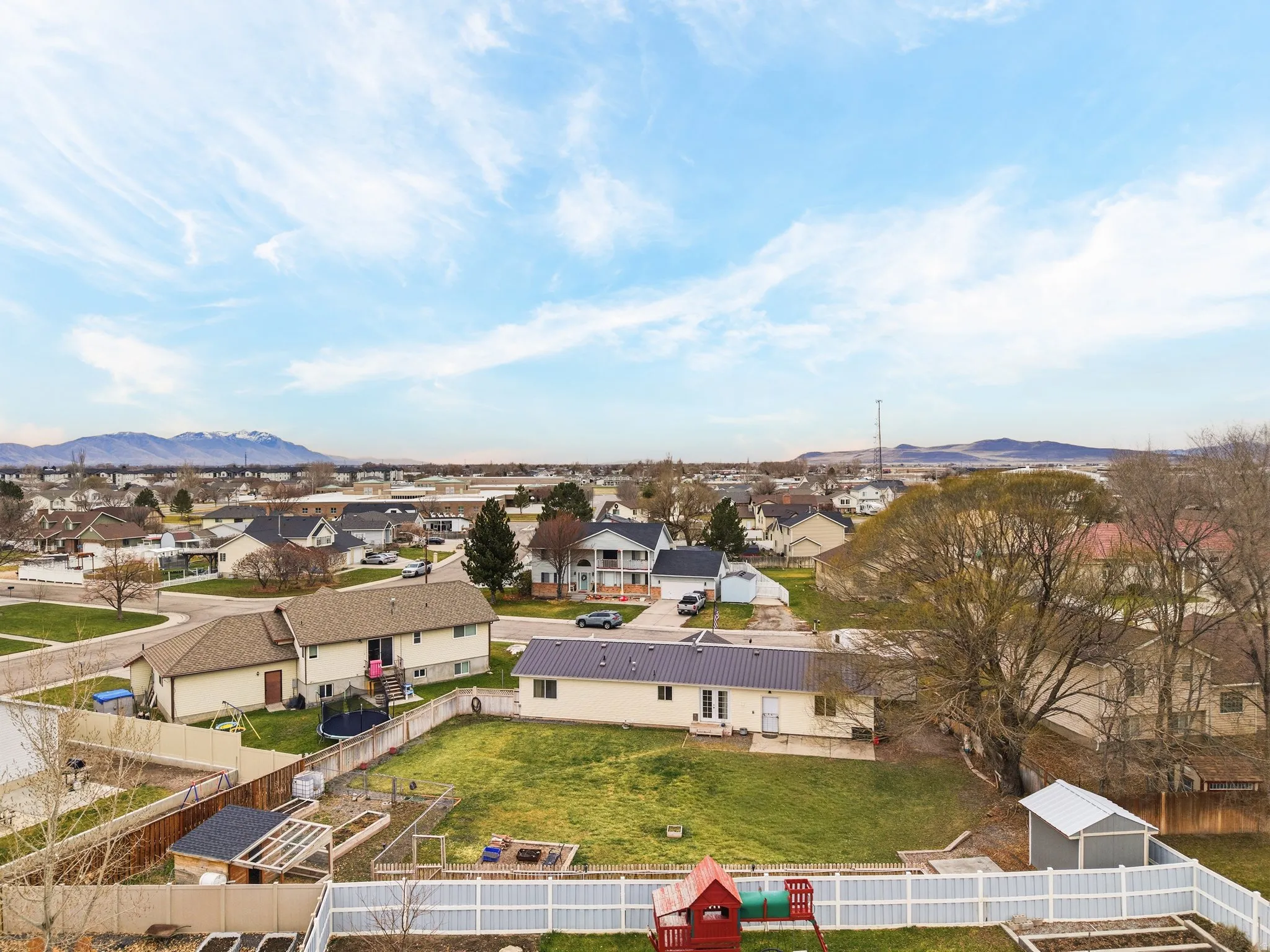 Aerial perspective of suburban area with a mountainous background