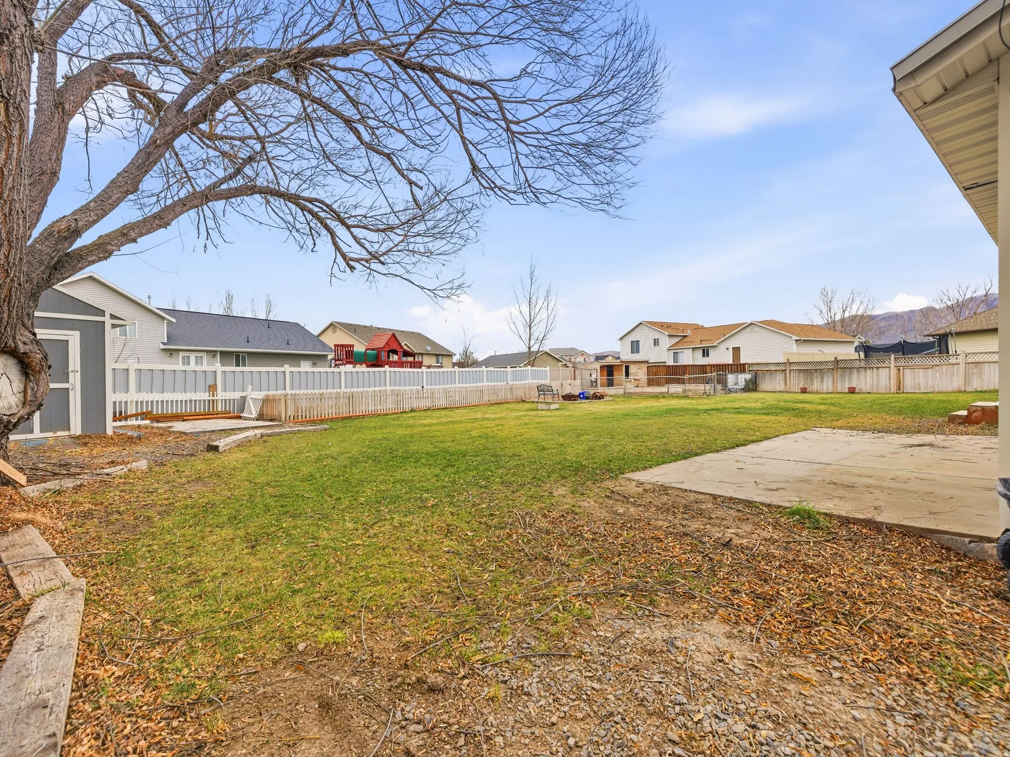 Fenced backyard featuring a residential view and a patio area