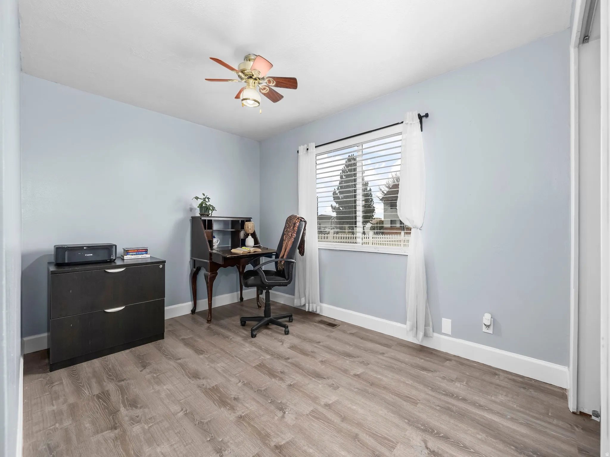 Office featuring light wood finished floors and ceiling fan