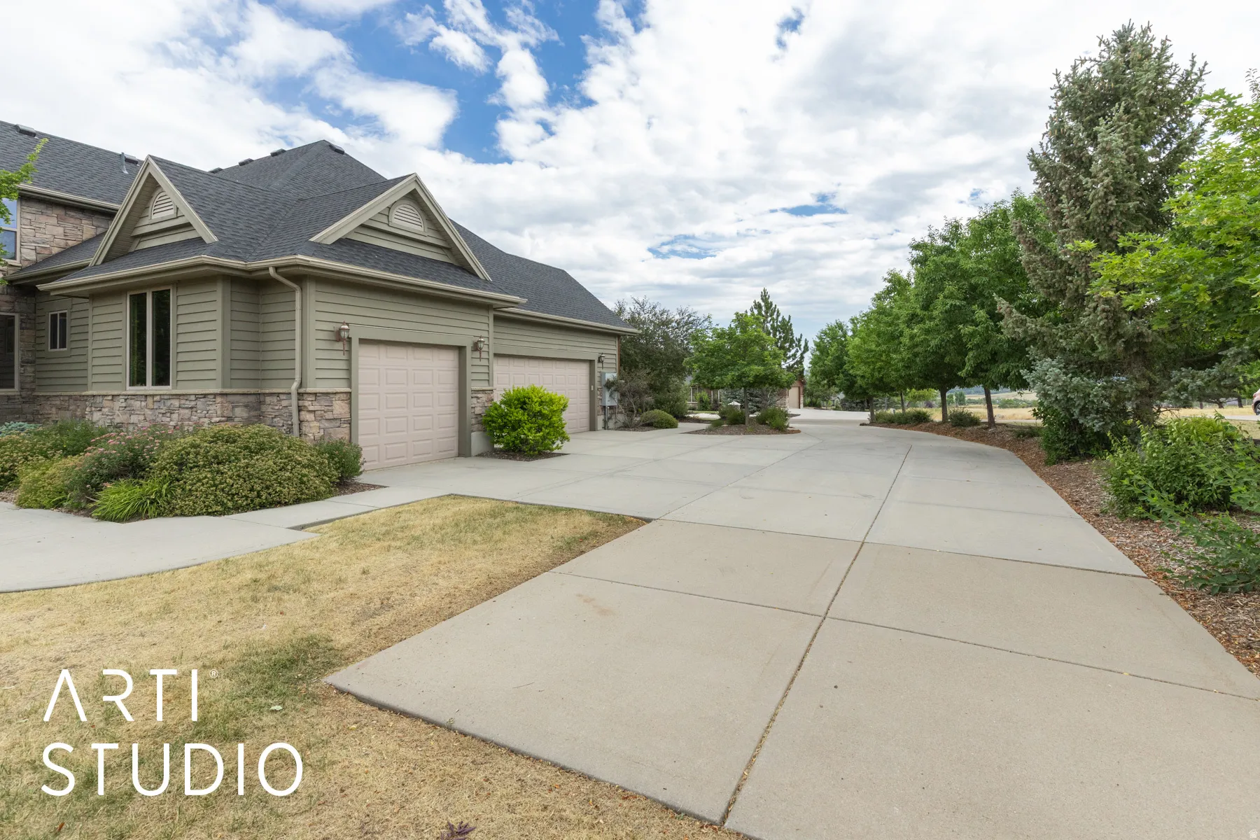 View of property exterior featuring driveway, stone siding, roof with shingles, and an attached garage
