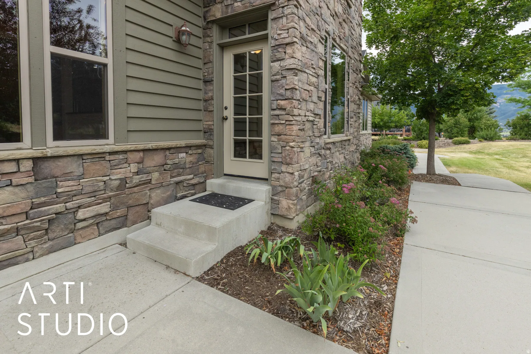Property entrance featuring stone siding