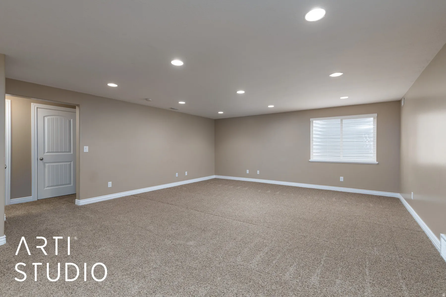 Empty room with recessed lighting and light carpet