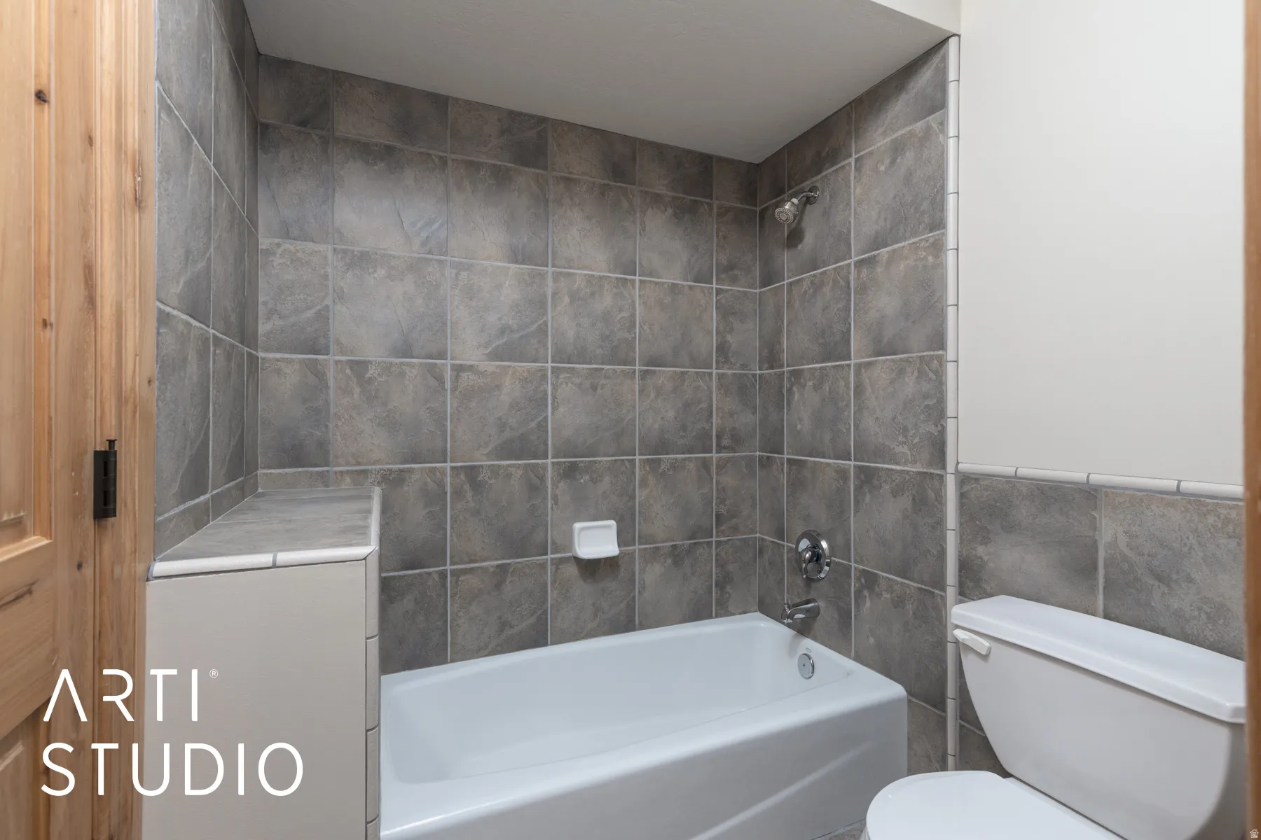 Bathroom with shower / bathtub combination and tile walls