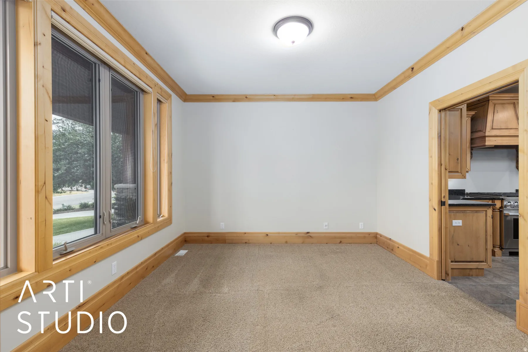 Empty room with light colored carpet and ornamental molding