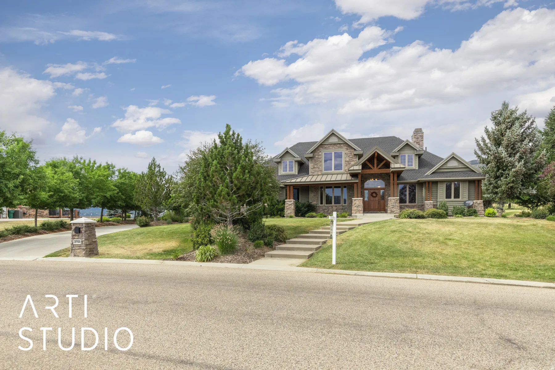 Craftsman house with stone siding, a front lawn, covered porch, and a chimney
