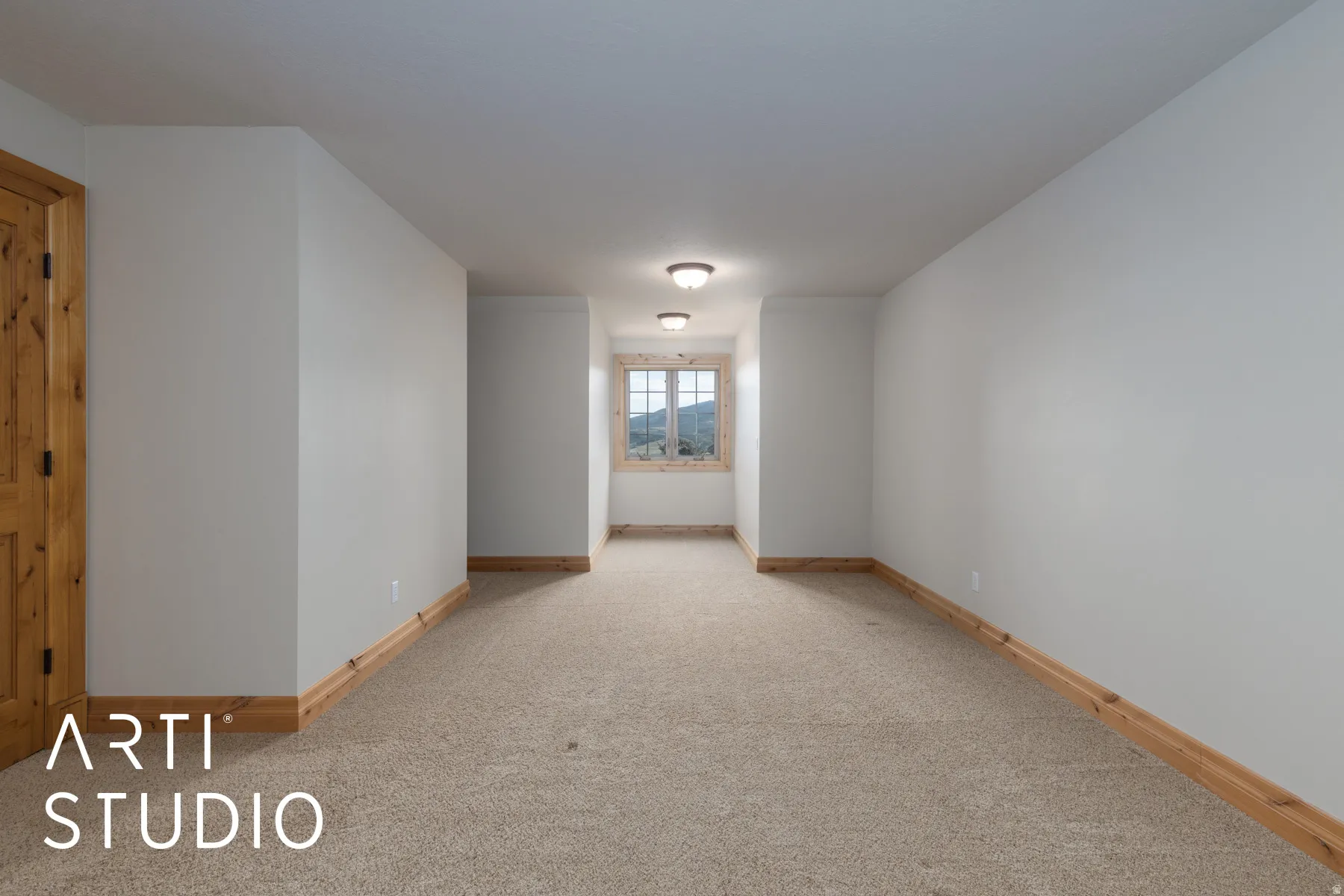 Spare room featuring baseboards and light carpet