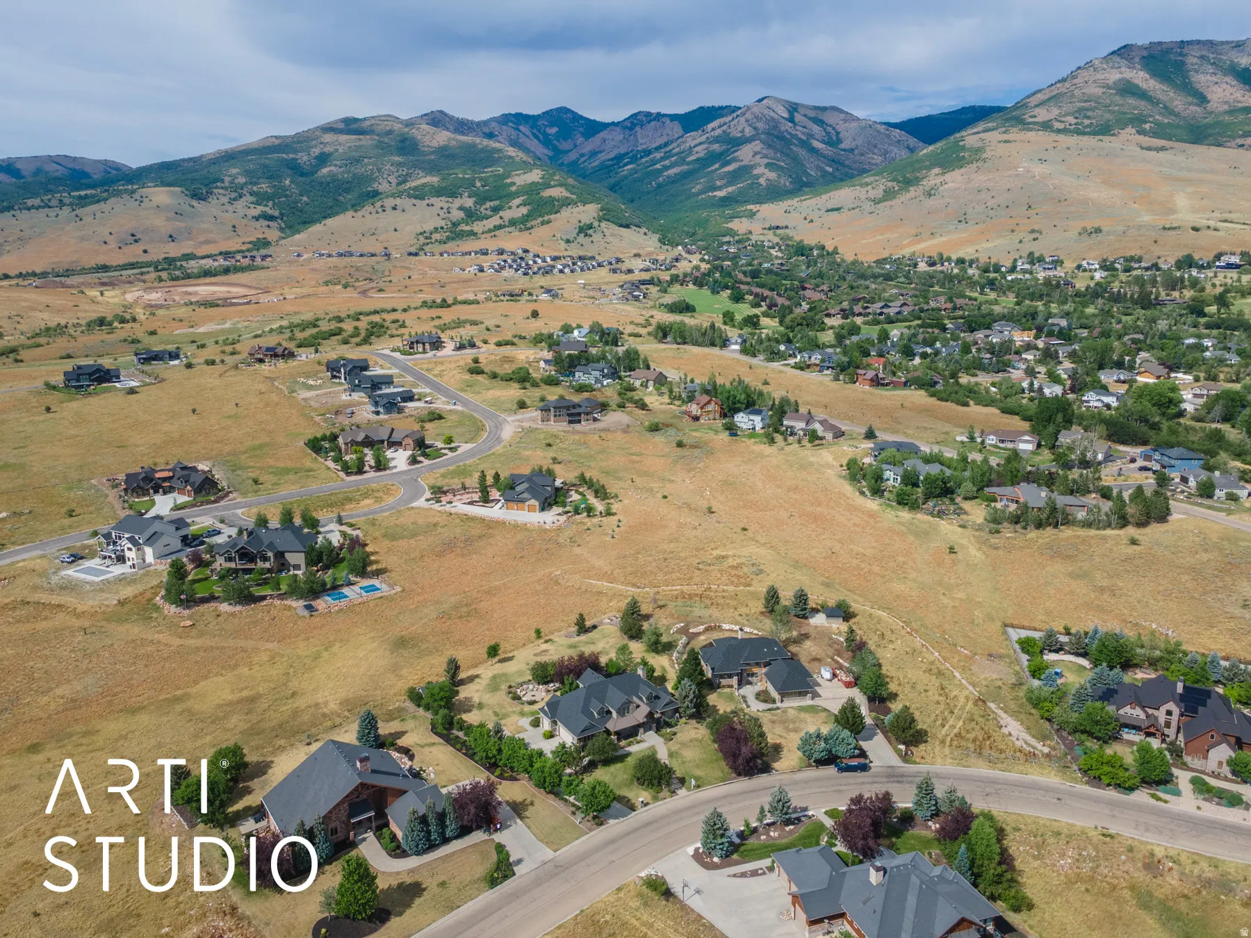 Aerial overview of property's location featuring mountains and nearby suburban area