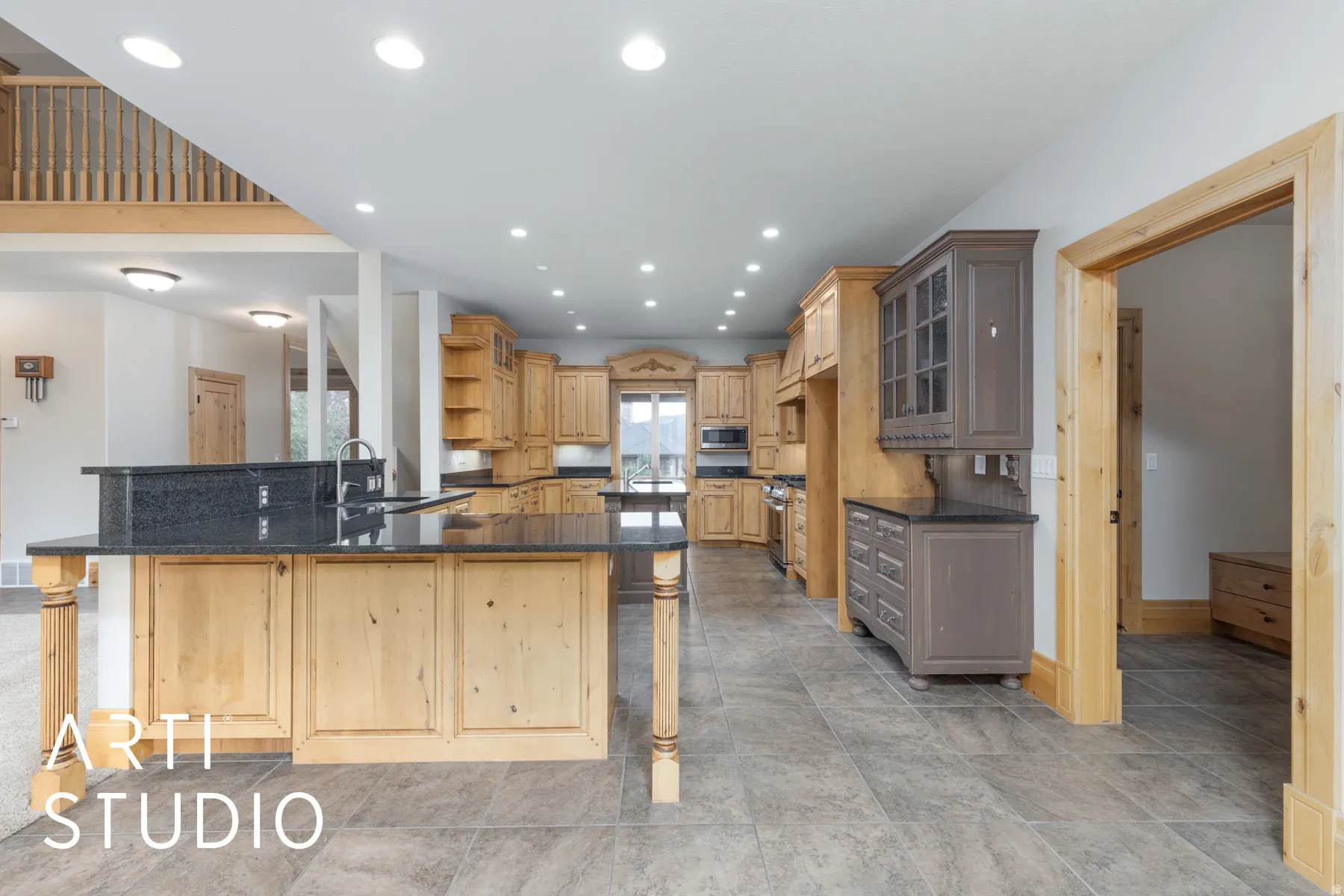 Kitchen with a peninsula, recessed lighting, open shelves, a breakfast bar, and glass insert cabinets