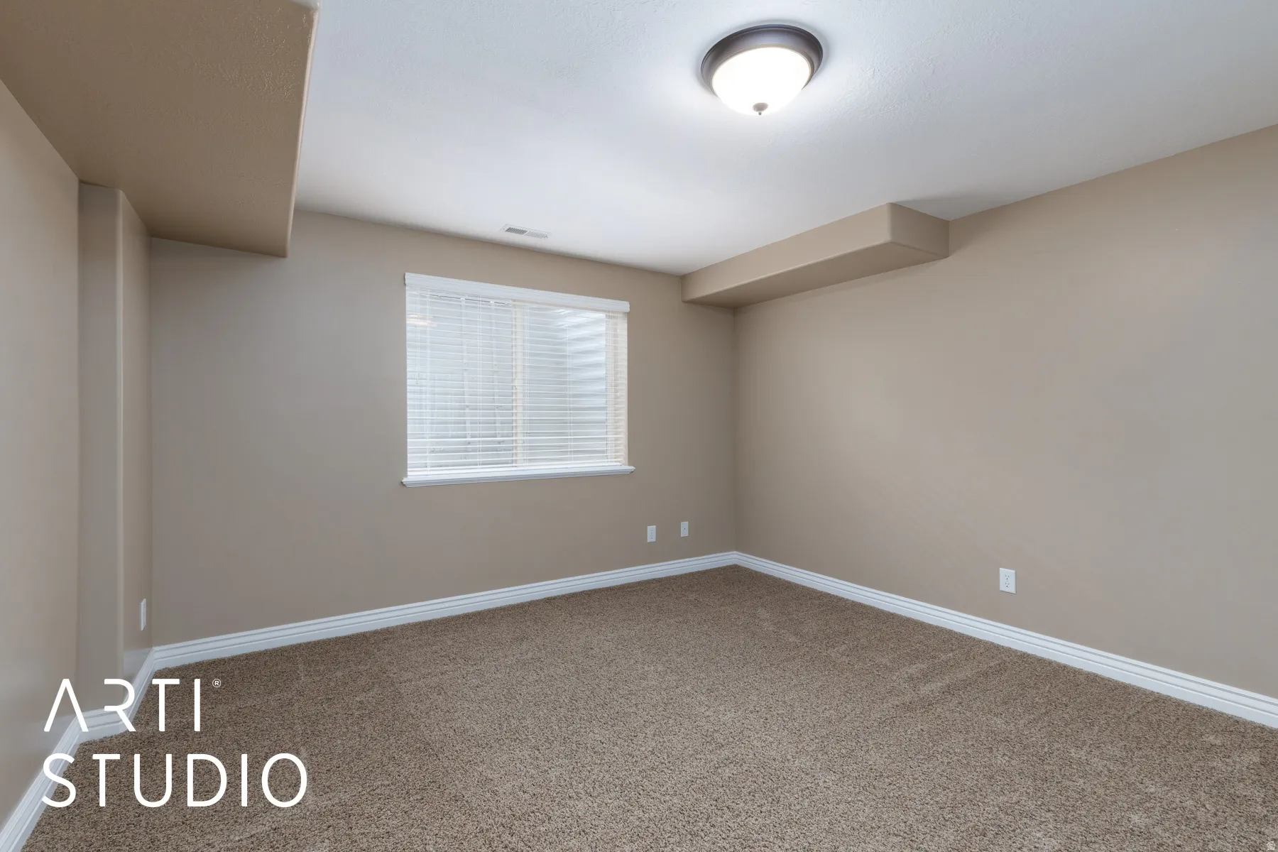 Unfurnished room featuring baseboards and light colored carpet