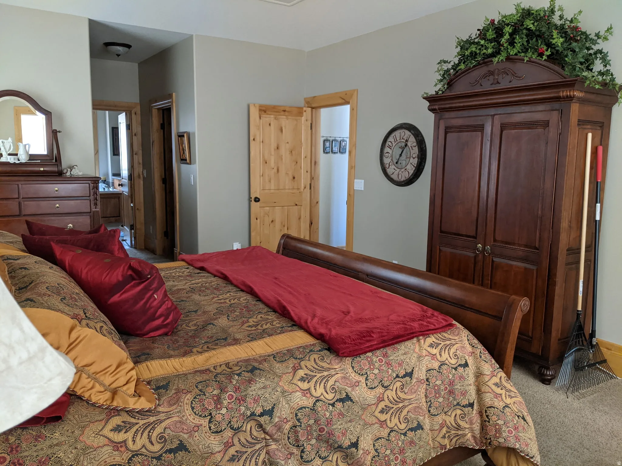 Bedroom featuring carpet flooring and ensuite bathroom