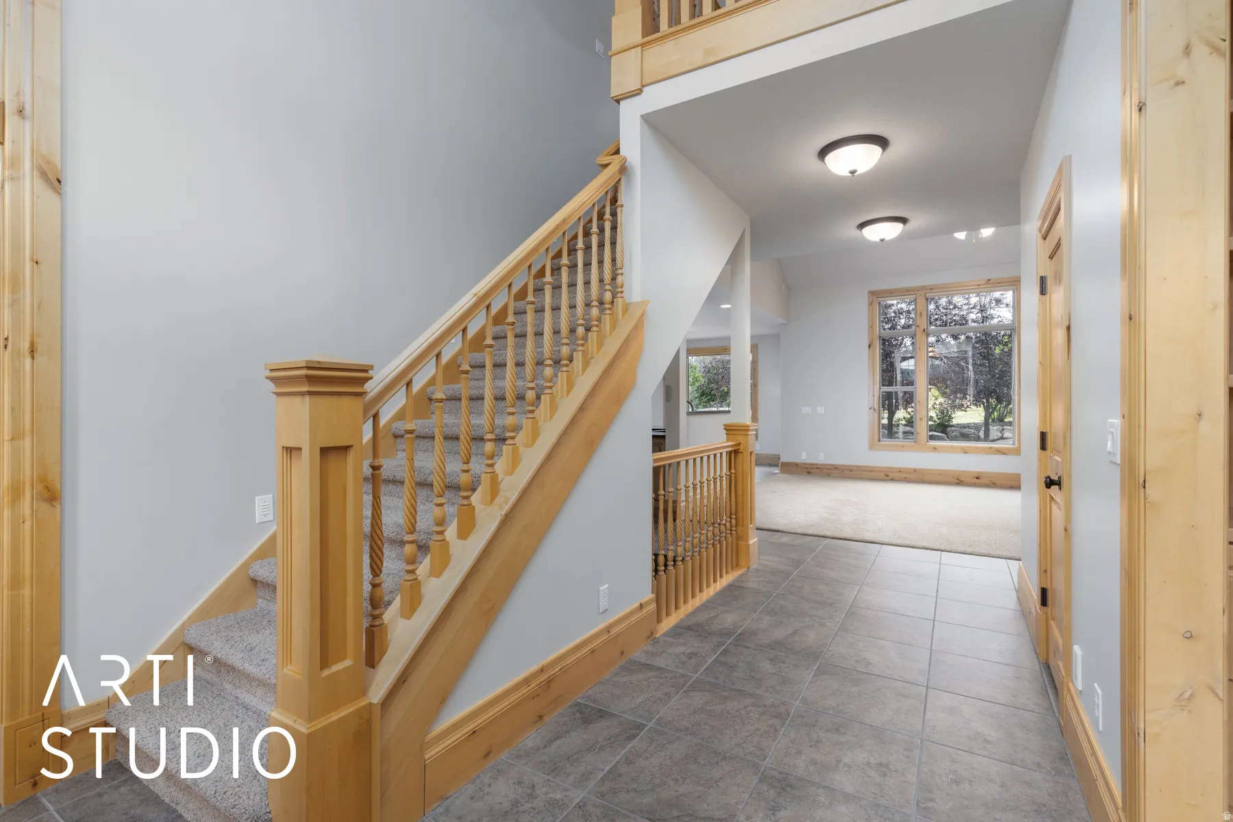 Stairway featuring tile patterned flooring and carpet