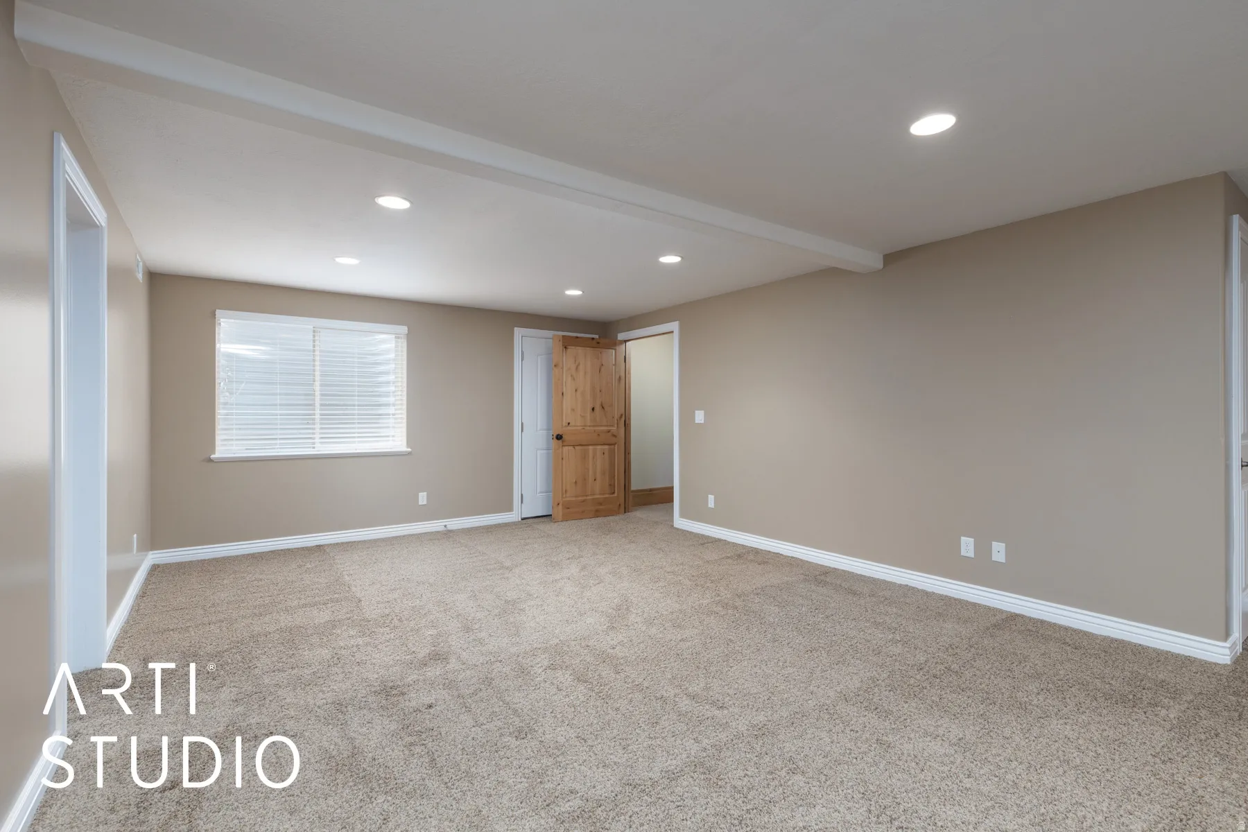 Empty room featuring recessed lighting, beam ceiling, and light colored carpet