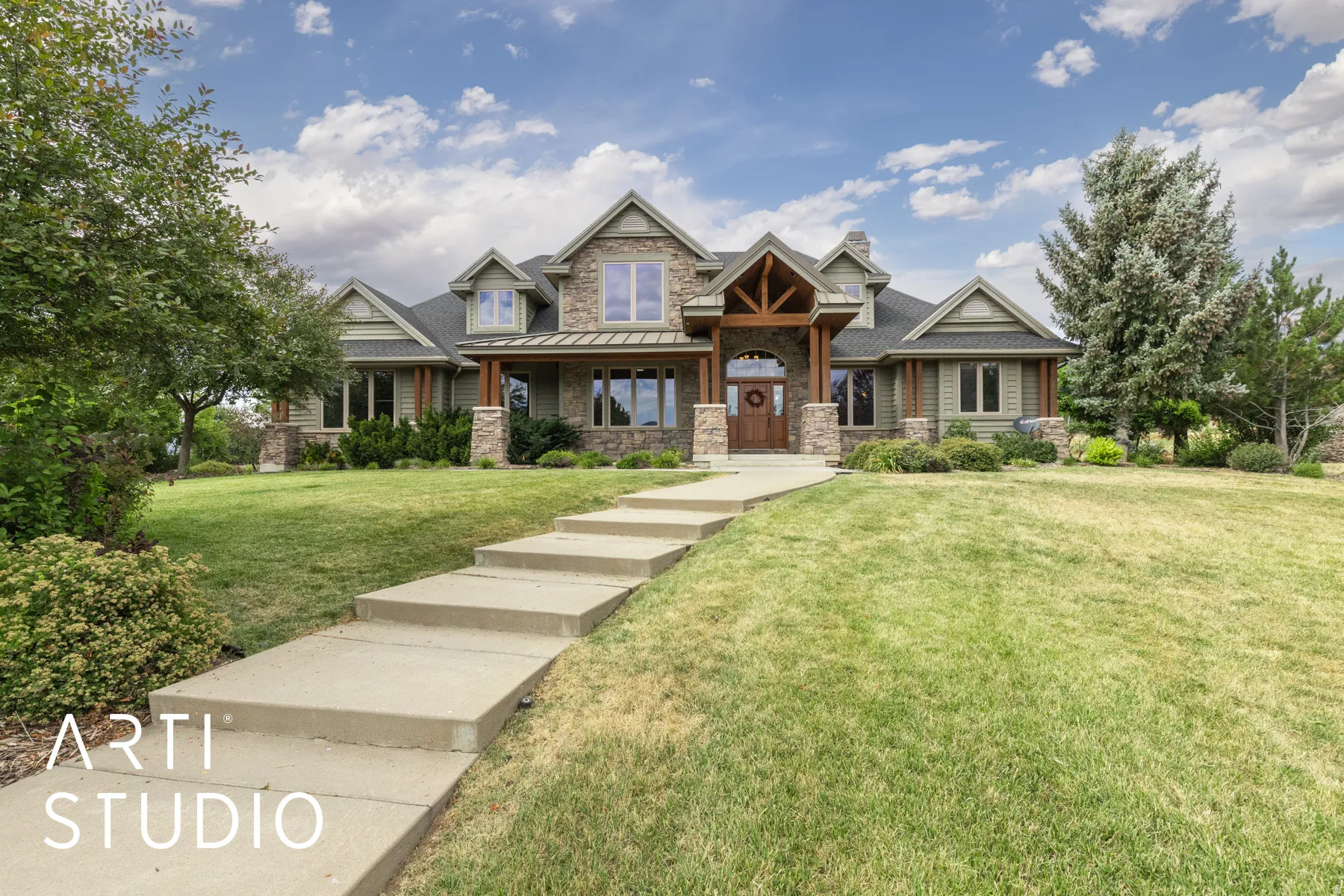 Craftsman house with stone siding, a porch, and a front yard