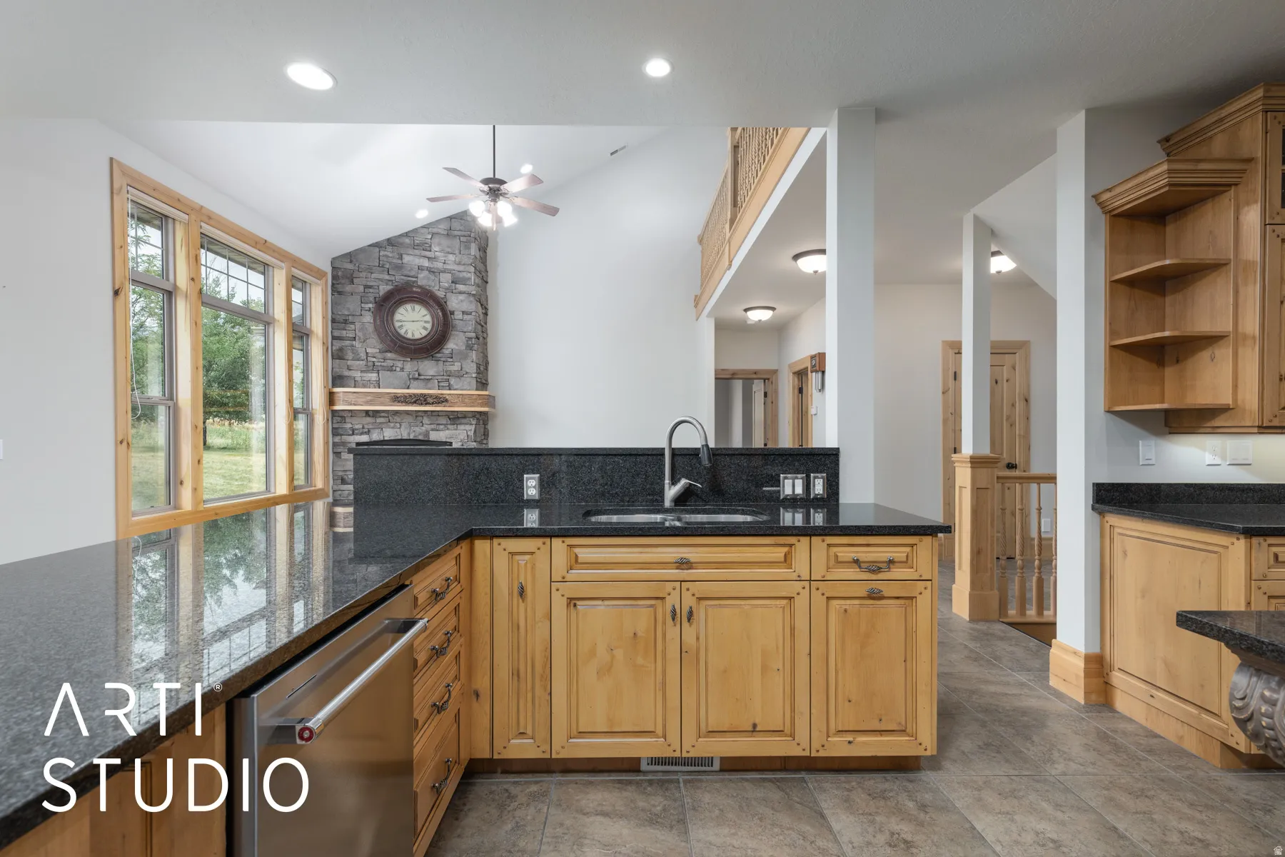 Kitchen featuring open shelves, dishwasher, dark stone counters, ceiling fan, and vaulted ceiling