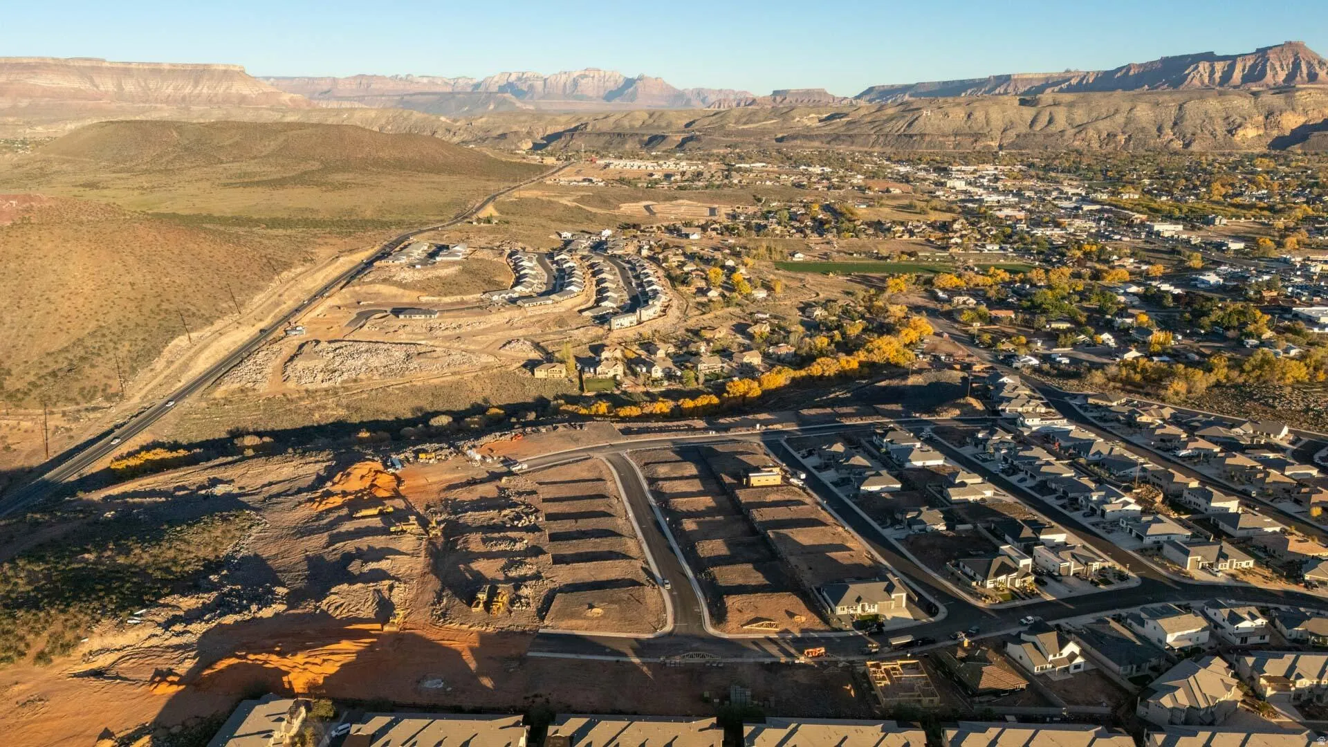 Aerial view of property and surrounding area featuring a mountainous background