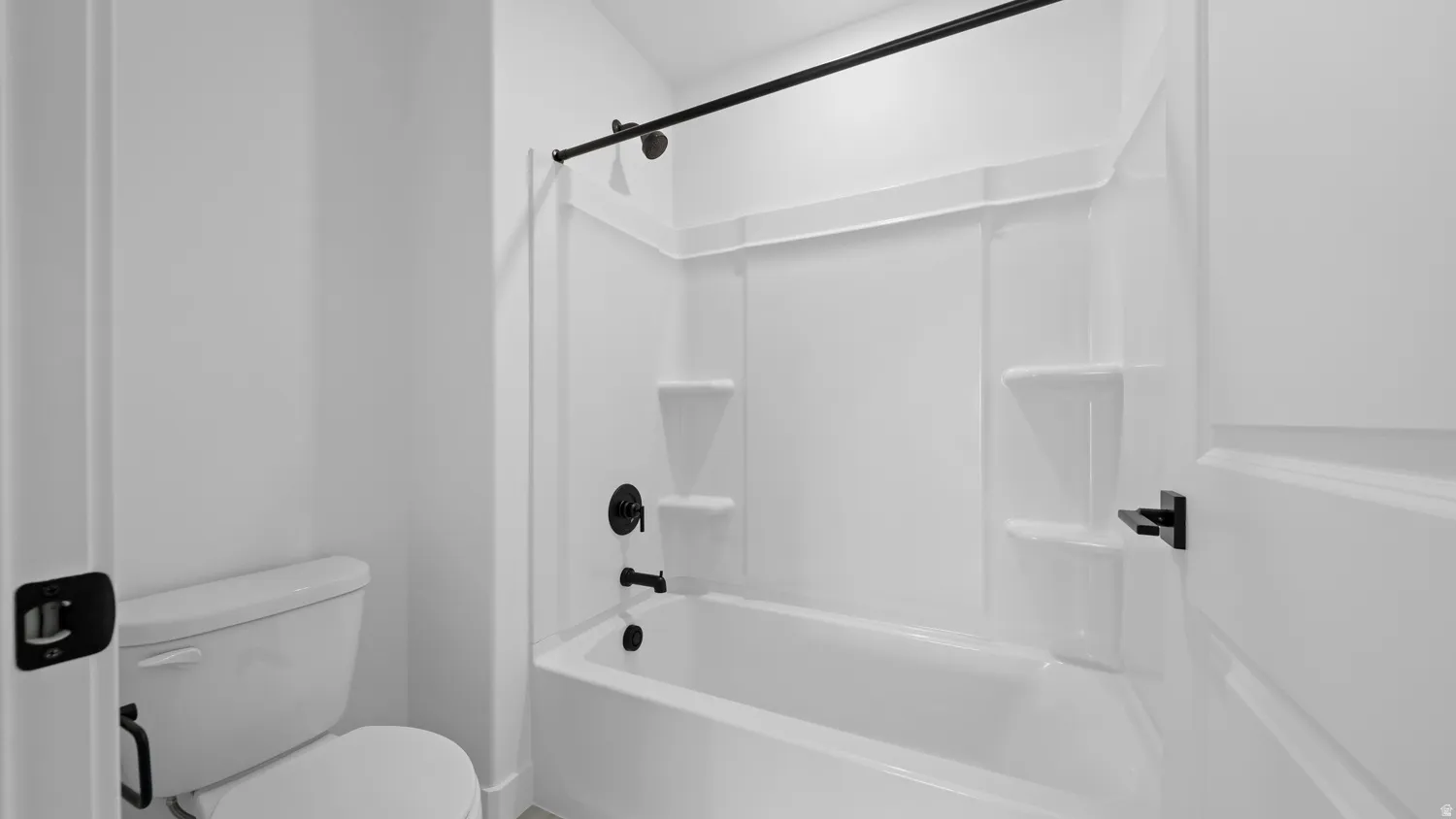 Full bathroom featuring toilet and bathing tub / shower combination