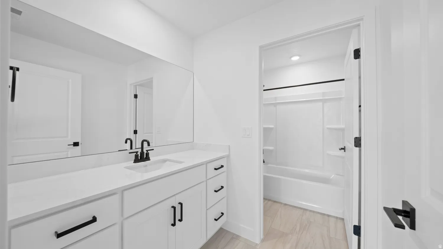 Bathroom with vanity and shower / bath combination