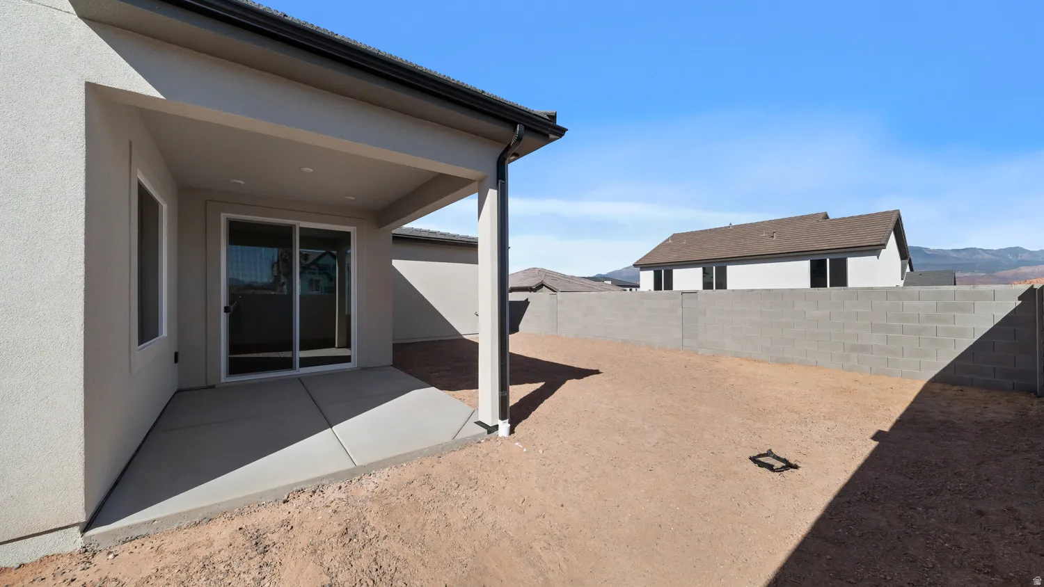 Fenced backyard with a patio area and a mountain view