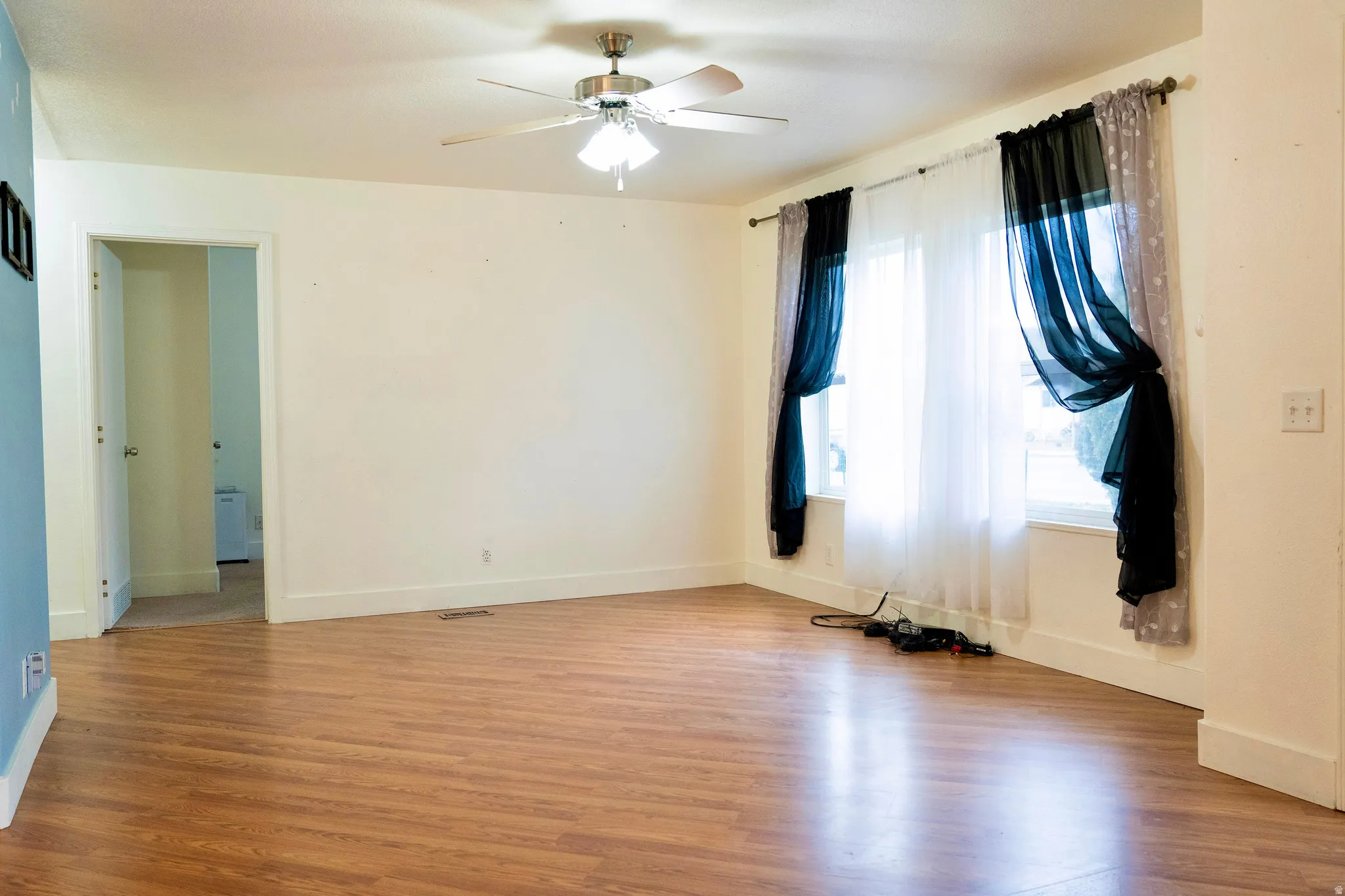 Spare room with light wood-style flooring and a ceiling fan