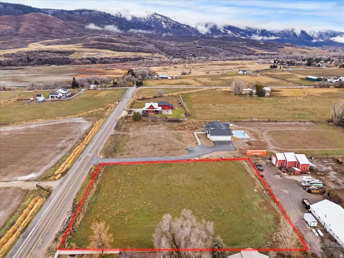 Overview of rural landscape with mountains and property parcel outlined