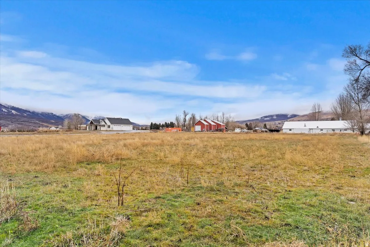 View of yard featuring a view of rural / pastoral area and a mountain view
