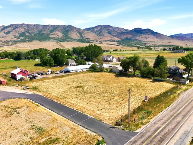 Expansive undeveloped lot featuring a paved road frontage and mountain scenery