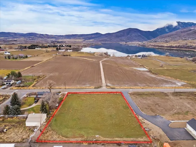 Aerial view of property's location featuring property parcel outlined and a water and mountain view